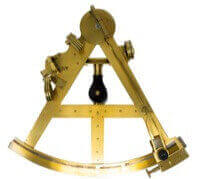 A brass sextant. It is triangular with an arc on the bottom.