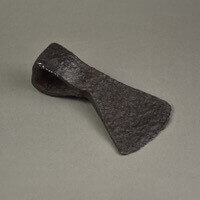 Rusty metal axe head. Has a hatchet style design.
